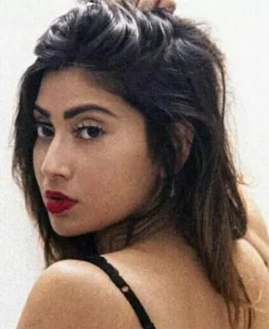 Portrait crop of an adult woman in a black strappy top