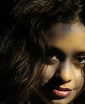Close-up portrait of an adult woman in dramatic light